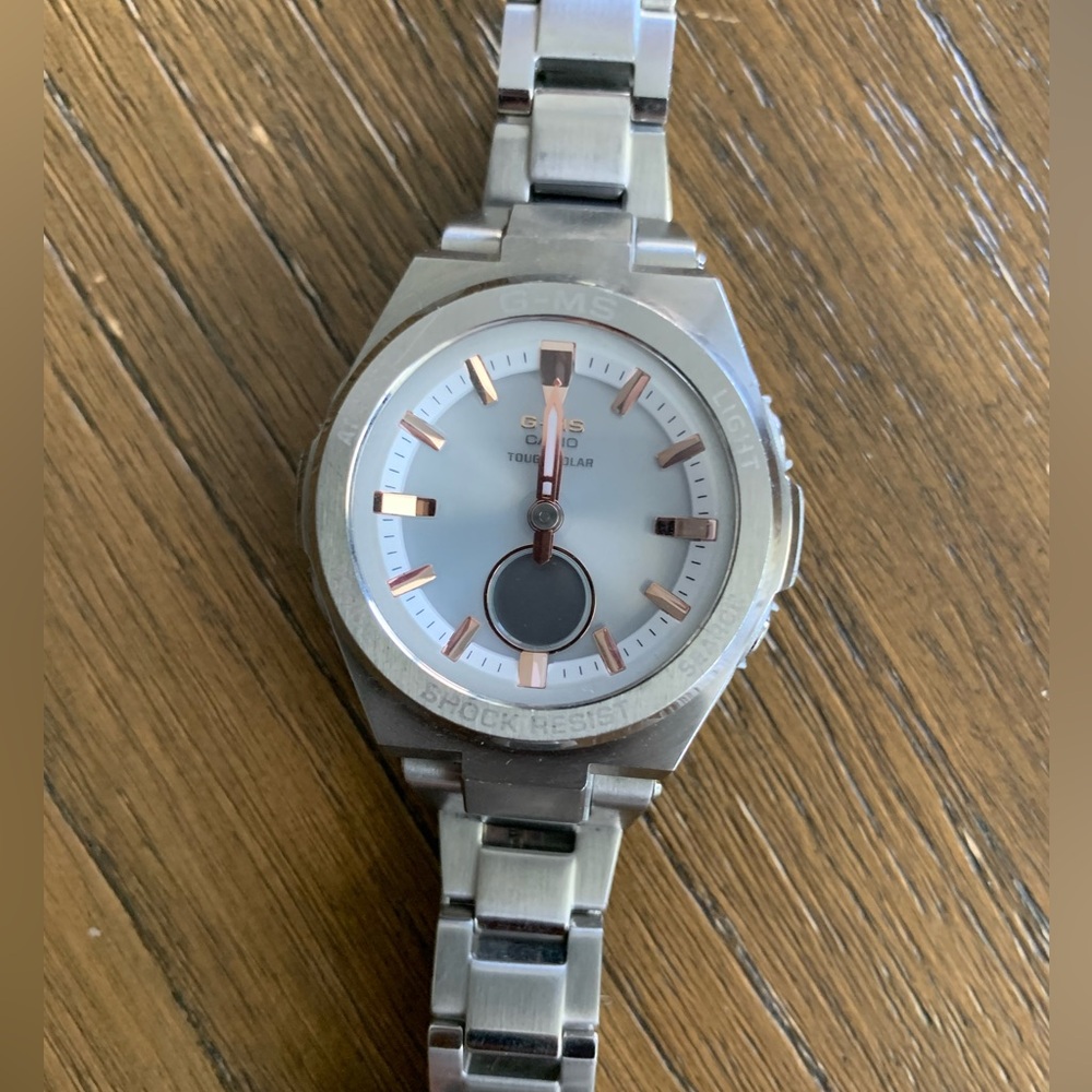 Well kept G shock sliver watch with rose gold accents.